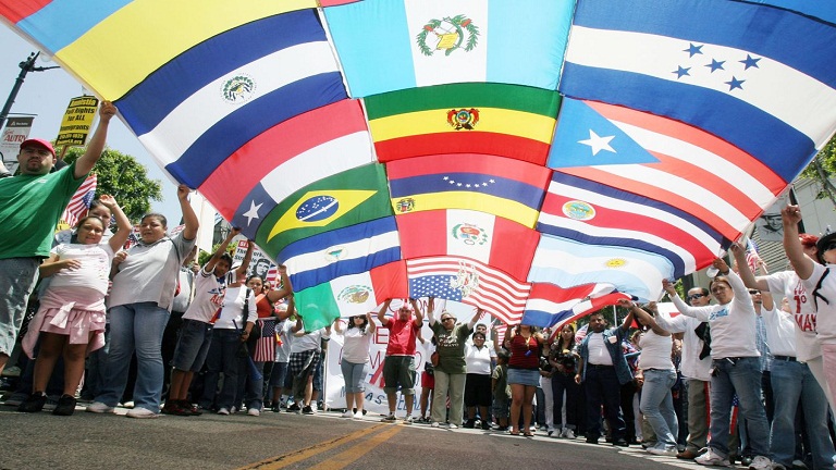 LOS ANGELES - JUNE 24:  A composite of numerous flags from across the world is held by immigrant reform supporters as they march on Hollywood Boulevard in support of the legalization of millions of undocumented immigrants living in the United States June 24, 2007 in Los Angeles, California. Fire officials estimated the crowd in attendance was around three thousand people.  (Photo by J. Emilio Flores/Getty Images)